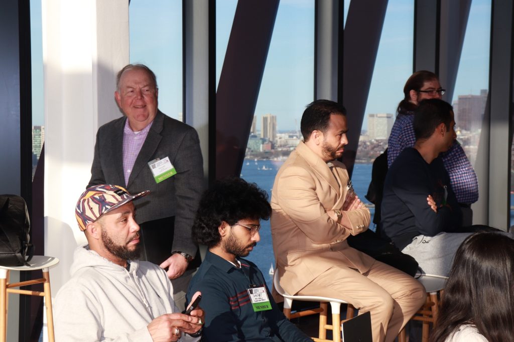 Audience at a BBA panel overlooking the Boston skyline