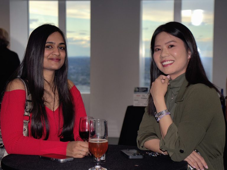 Two women smiling at a BBA evening event